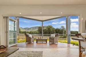 an open living room with a view of the mountains at Brokenback Views Country Estate Hunter Valley in Pokolbin
