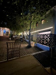 a bench sitting in front of a building at night at Studio with Sauna & Massage in Kampala