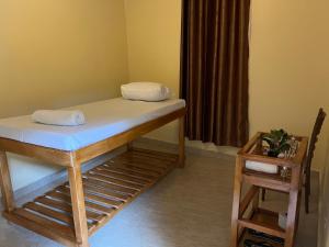 a bed with two pillows on it in a room at Studio with Sauna & Massage in Kampala