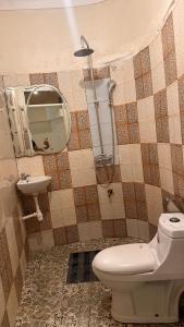 a bathroom with a toilet and a sink at Studio with Sauna & Massage in Kampala