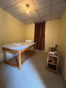 a room with a bed in the corner of a room at Studio with Sauna & Massage in Kampala +4 photos