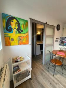 a room with a painting on the wall and a table at Champoiseau in Tours