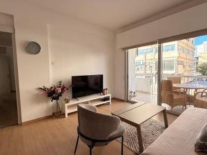 a living room with a flat screen tv and a couch at Mimosa flat City Cente 2bdr in Nicosia