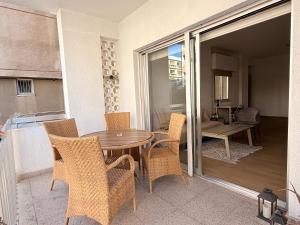 a patio with a table and chairs on a balcony at Mimosa flat City Cente 2bdr in Nicosia
