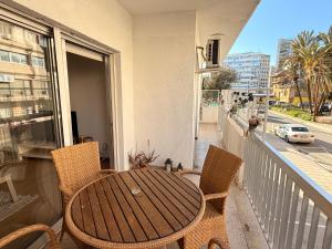 a table and chairs on a balcony with a view of a street at Mimosa flat City Cente 2bdr in Nicosia