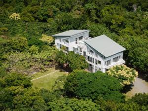 an aerial view of a large white house in the forest at Toptai Kenting BY REINDEER in Kenting