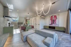 a living room with a couch and a chandelier at XO Canggu adults only in Canggu