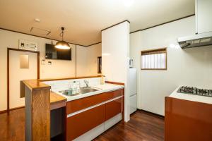 a kitchen with a sink and a stove at Dream Bridge Fuji House in Fuji