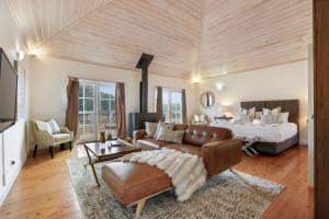 a living room with a couch and a bed at Brokenback Views Country Estate Hunter Valley in Pokolbin +17 photos