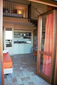 a living room with a staircase and a kitchen at Borgo Castel Savelli in Grottaferrata