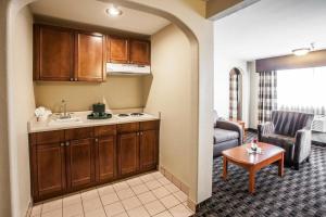 a kitchen and living room with a couch and a table at Clarion Inn Renton-Seattle in Renton +23 photos