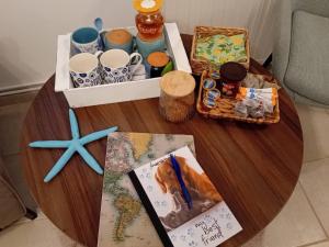 a wooden table with a table with cups and a box at Studio Lemoni Peloponnese in Pirgákion