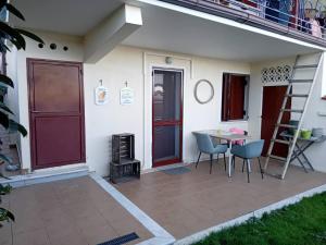 a patio with a table and chairs next to a house at Studio Lemoni Peloponnese in Pirgákion