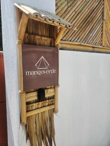 a sign on the side of a building at Mangoverde Guesthouse in Moalboal