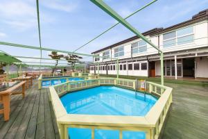 a pool on the deck of a building at Abientot Spa Pension Ganghwa in Incheon