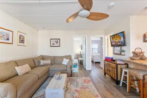 a living room with a couch and a ceiling fan at Surfside Getaway with Heated Pool & BBQ Grill in North Wildwood
