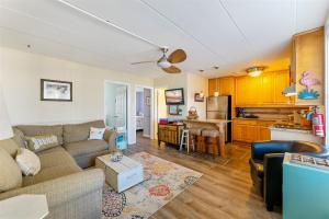 a living room with a couch and a kitchen at Surfside Getaway with Heated Pool & BBQ Grill in North Wildwood