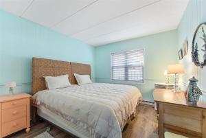a bedroom with a bed and a desk and a window at Surfside Getaway with Heated Pool & BBQ Grill in North Wildwood +13 photos