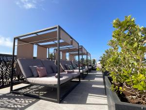 a row of chairs on a balcony with plants at Pietro Boutique Hotel and Villas in Għarb