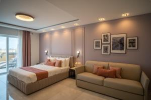a bedroom with a bed and a couch at Pietro Boutique Hotel and Villas in Għarb