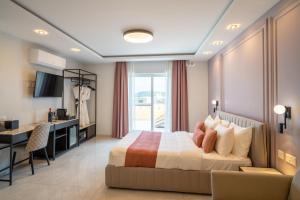 a bedroom with a bed and a desk and a kitchen at Pietro Boutique Hotel and Villas in Għarb