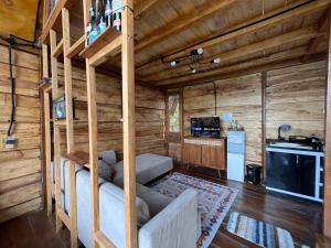 a living room with a couch in a log cabin at Satha private villa Dieng in Banjarnegara +18 photos