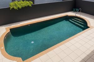 a swimming pool with a golf ball in it at Redcliffe Villa in Redcliffe