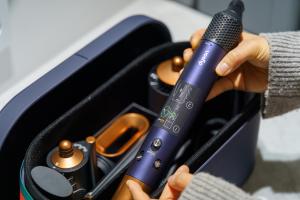 a person holding a microphone in a case at Hotel Hariu in Gwangju
