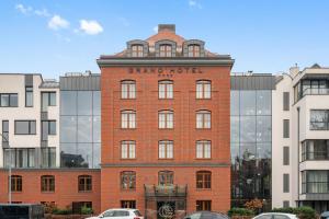 a red brick building with a sign on it at GRANO HOTEL Gdańsk Riverside in Gdańsk