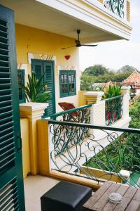 a balcony of a house with a table and chairs at Golden Banana Residence in Siem Reap