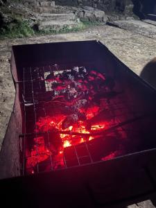 a grill with a red fire inside of it at Manjosila Homestay in Mirik
