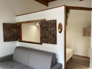 a living room with a couch and a mirror at Studio cosy -Hyper centre -Tout à pied in Paray-le-Monial