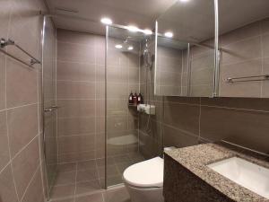 a bathroom with a shower and a toilet and a sink at RUNA Stay HAEUNDAE in Busan +48 photos