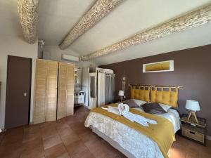 a bedroom with a large bed with towels on it at Appel du Luberon in Mérindol +47 photos