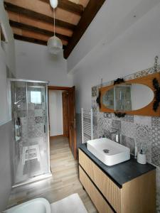 a bathroom with a glass shower and a sink at Il Peppolo Country House in Pelago +10 photos