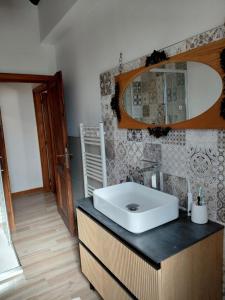 a bathroom with a sink and a mirror at Il Peppolo Country House in Pelago
