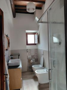 a bathroom with a toilet and a sink and a shower at Il Peppolo Country House in Pelago