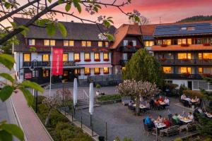 a group of people sitting outside of a building at Hotel Hochfirst in Lenzkirch