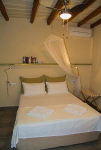 a bedroom with a bed with two towels on it at Agapi Holiday House in Sívas