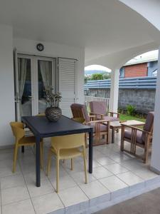 a blue table and chairs on a patio at Chez Francine in Le Tampon