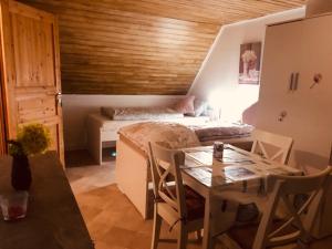 a room with a bed and a table and a bed and a dining room at Pension Nazli Lübeck in Lübeck