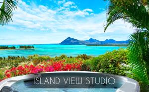 a sign that reads island view studio with a view of the water at Kozy Le Morne in Le Morne