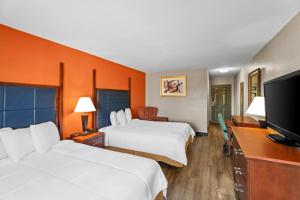 a hotel room with two beds and a flat screen tv at Rodeway Inn in Temple