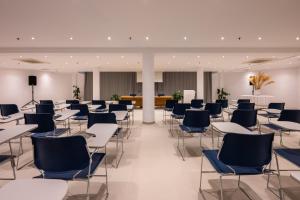 a classroom with desks and chairs in a building at The Majestic Hotel in Fira +44 photos