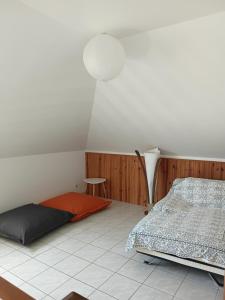 a bedroom with a bed and a table and a lamp at Chez Francine in Le Tampon