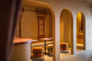 a bar with stools in a room with arches at SABLIER by R HOTEL in Osaka +46 photos