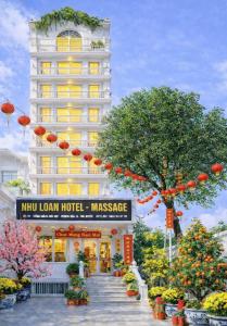 a hotel with a sign in front of a building at Hotel Nhu Loan in Bạch Ðoài