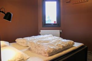 two unmade beds in a bedroom with a window at Stølstunets samlingssted in Beitostøl +8 photos