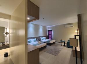 a hotel room with two beds and a bathroom at Waterworld Hotel Cebu in Mandaue City +40 photos