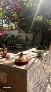 a table with a vase sitting on top of it at Arijaana Guesthouse in Gunjur